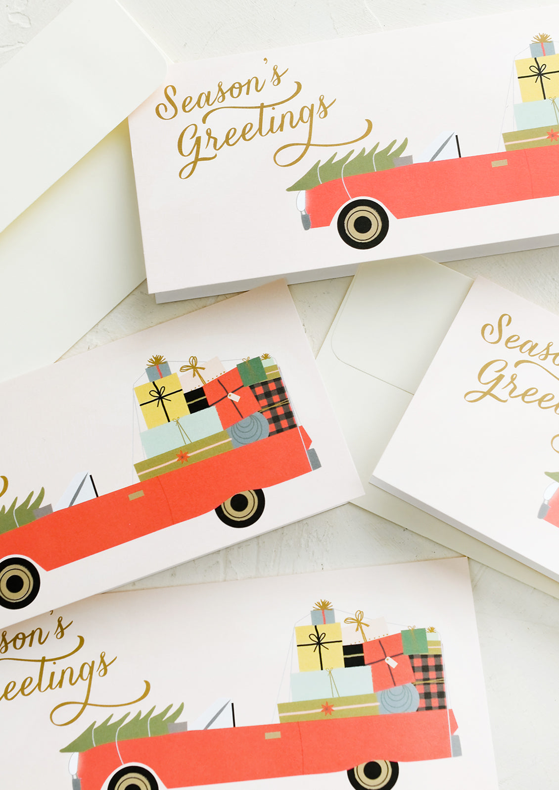 Rectangular greeting cards with car full of presents, text reads "Season's greetings".