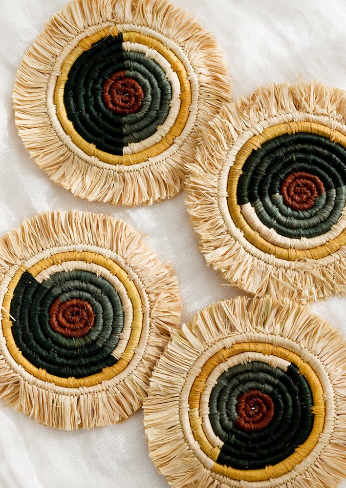 A set of circular raffia coasters with primary hue colorblocking.