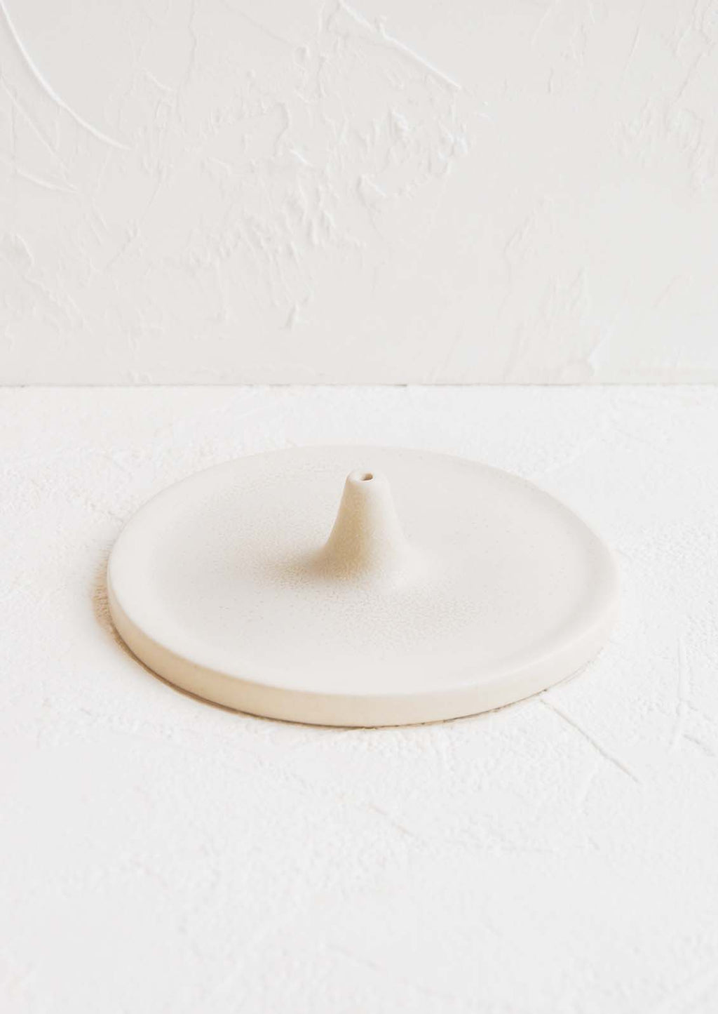 Bisque White: A circular ceramic incense holder in matte white.
