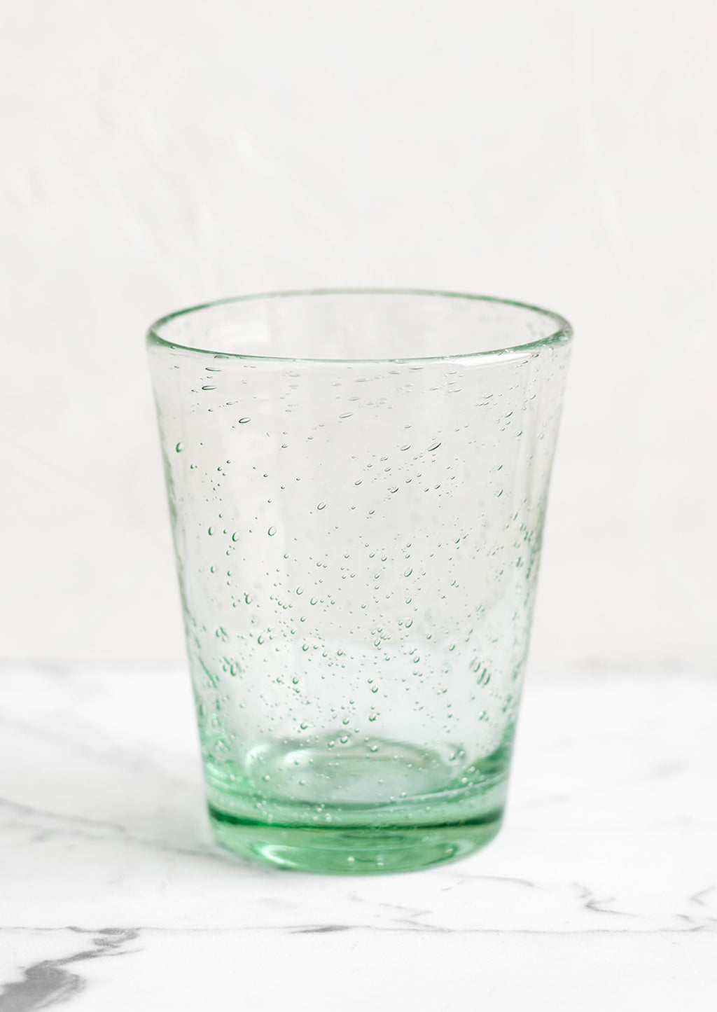 Bottle Green: A glass tumbler cup in light green seeded glass.