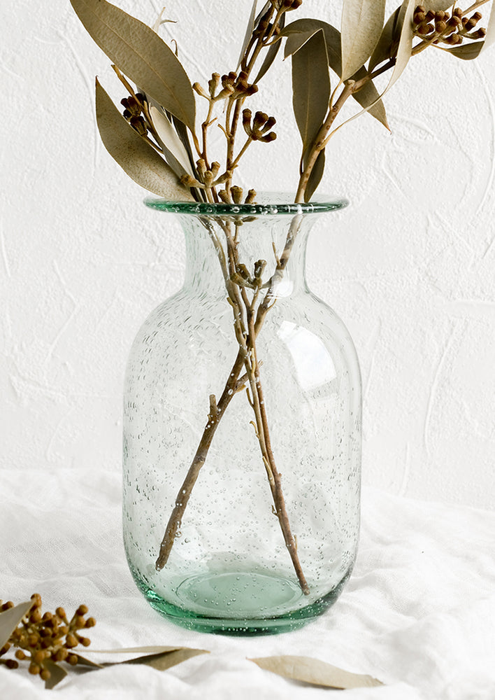 1: A seeded glass vase with dried eucaluptus.