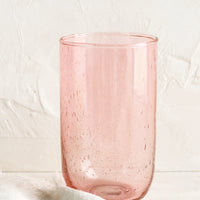Rose / 16 oz: A tall glass tumbler in seeded pink glass.