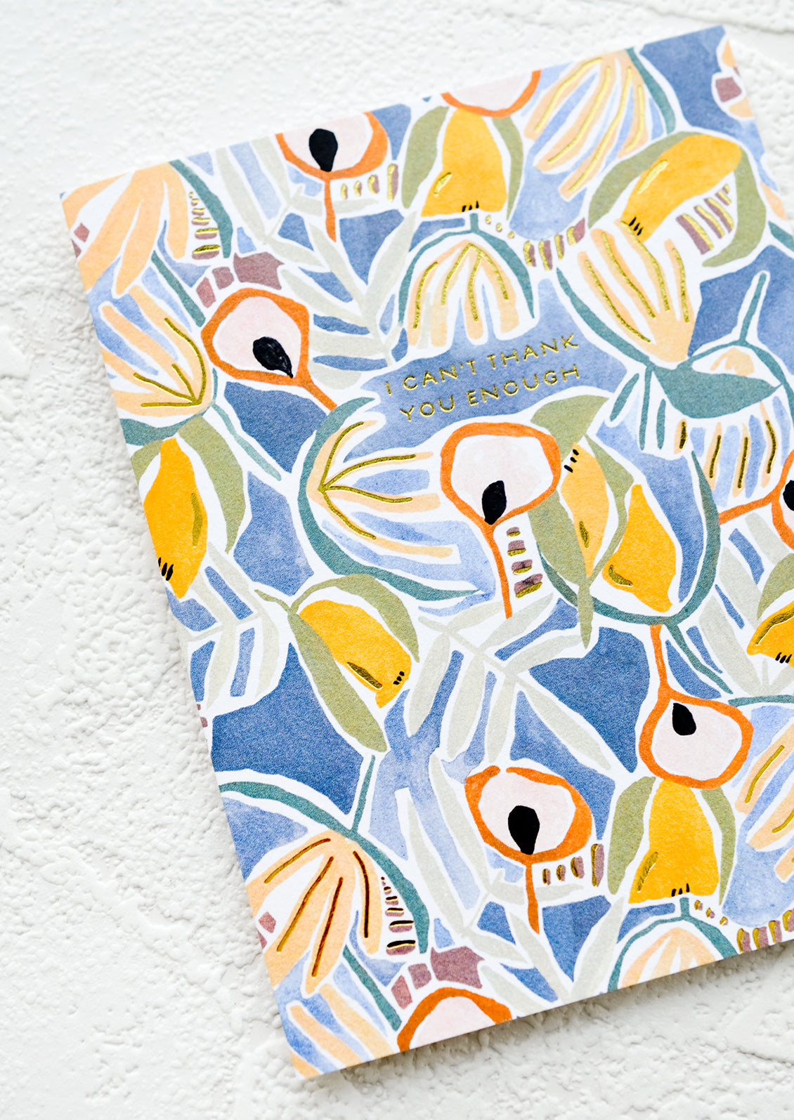 Floral print greeting card with "I can't thank you enough" printed in gold letters.