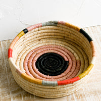 1: A round, shallow basket in colorful design.