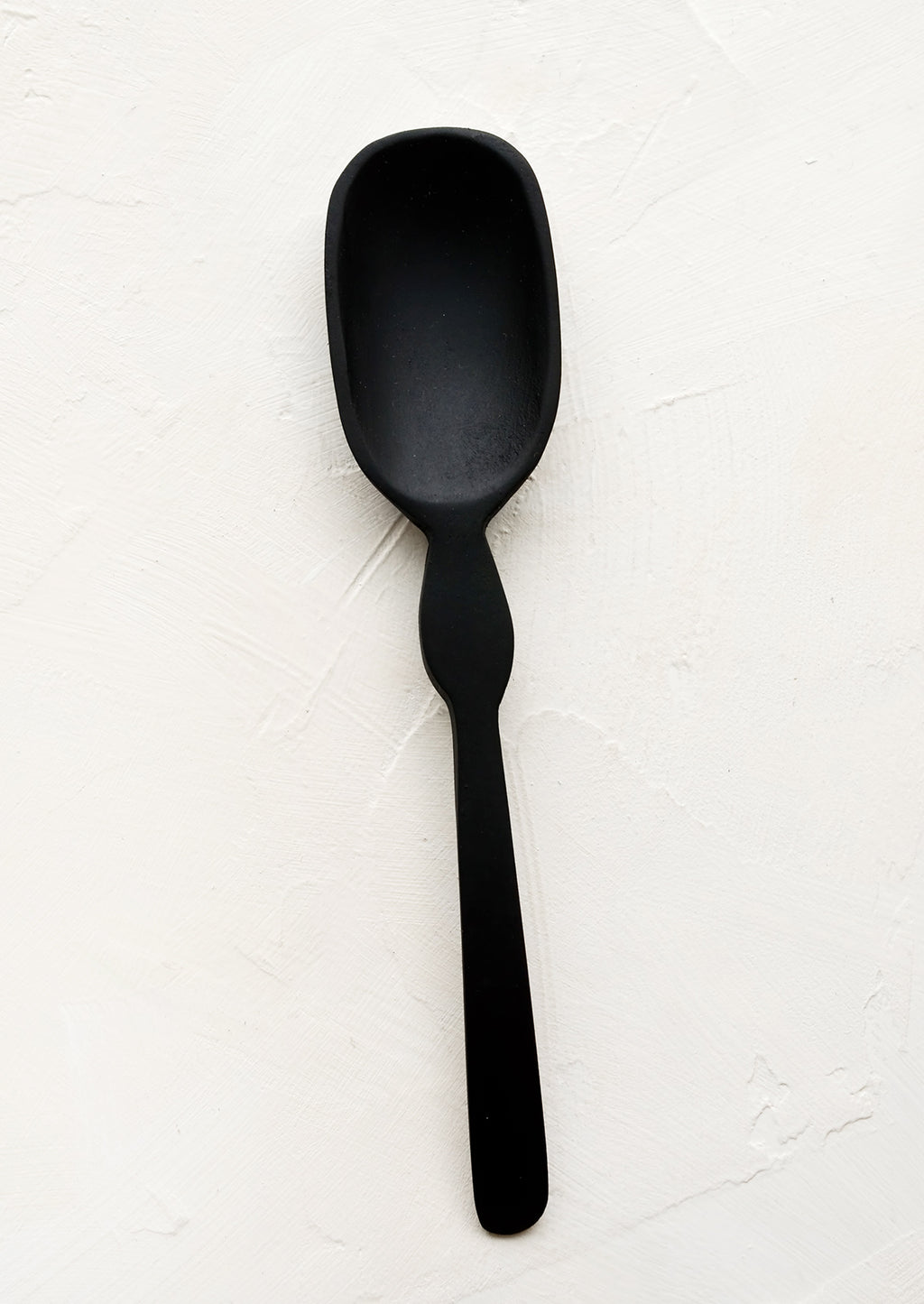 Standard: A carved black wooden spoon with decoratively curved handle.