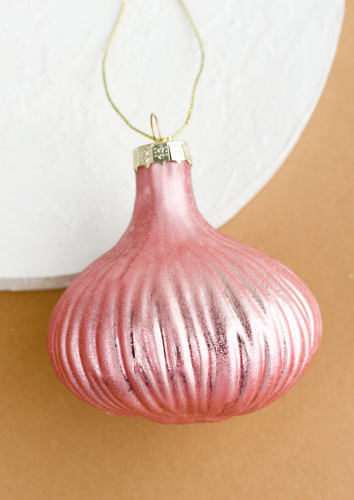 A glass ornament of a pink shallot onion.