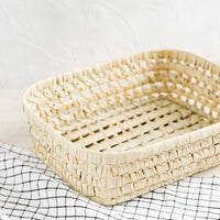Large: A shallow storage basket made from dried palm leaf.