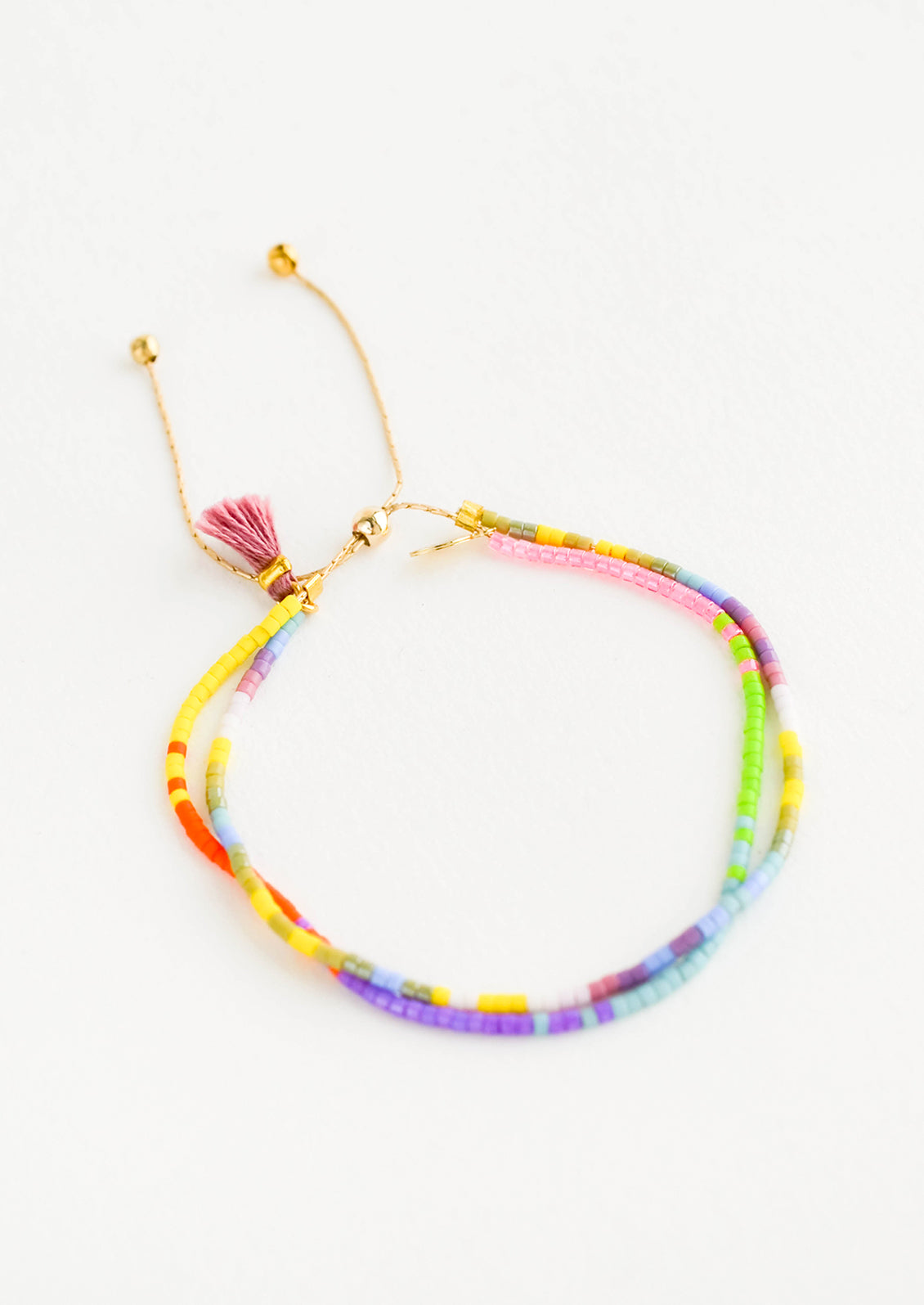 Beaded bracelet made up of two strands, beaded in bright multicolor seed beads with a gold metal closure