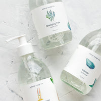 Atlantic: Glass pump bottles of liquid soap with nautical and beach themed labels and scents.