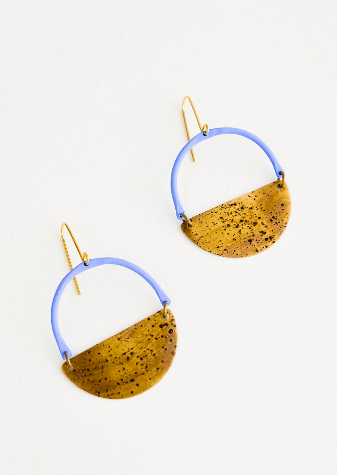 Earrings with blue arc shaped top and metal half moon shaped bottom with negative space in middle