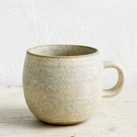 Matte Grey / Standard Mug: A ceramic coffee mug in a rustic, textured sandy glaze.