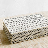 1: A decorative storage box made from ivory bone with black etched "slash" pattern.