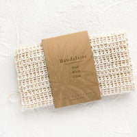 1: Natural sisal washcloth folded in its packaging