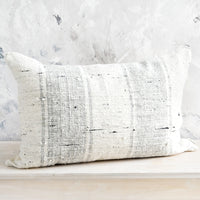 4: Lumbar throw pillow in textured cotton slub fabric with light grey vertical stripes.