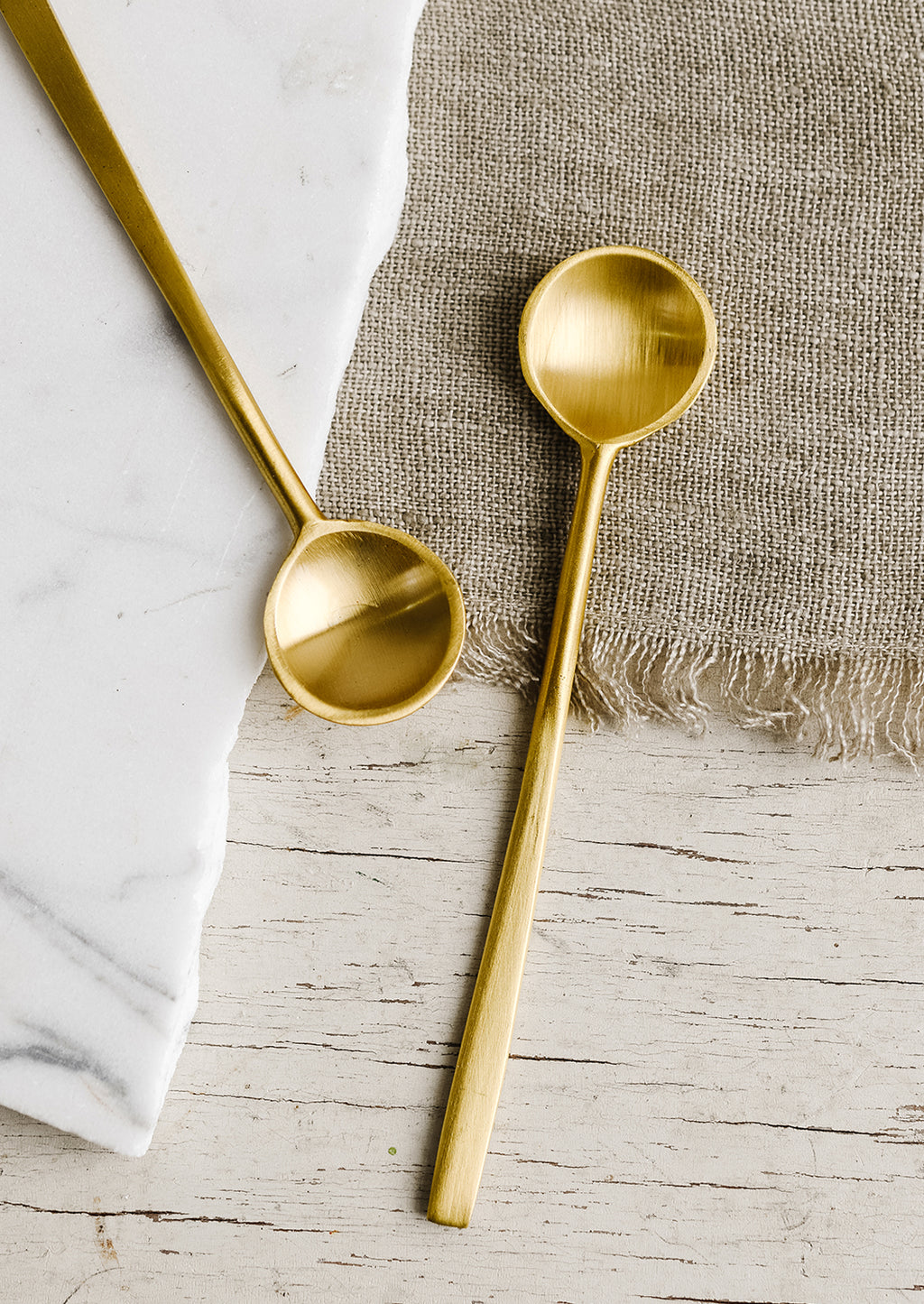 1: Small brass spoons.