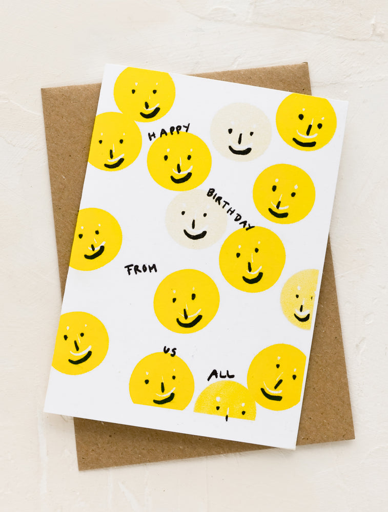 1: A greeting card with smiley faces reading "happy birthday from us all".