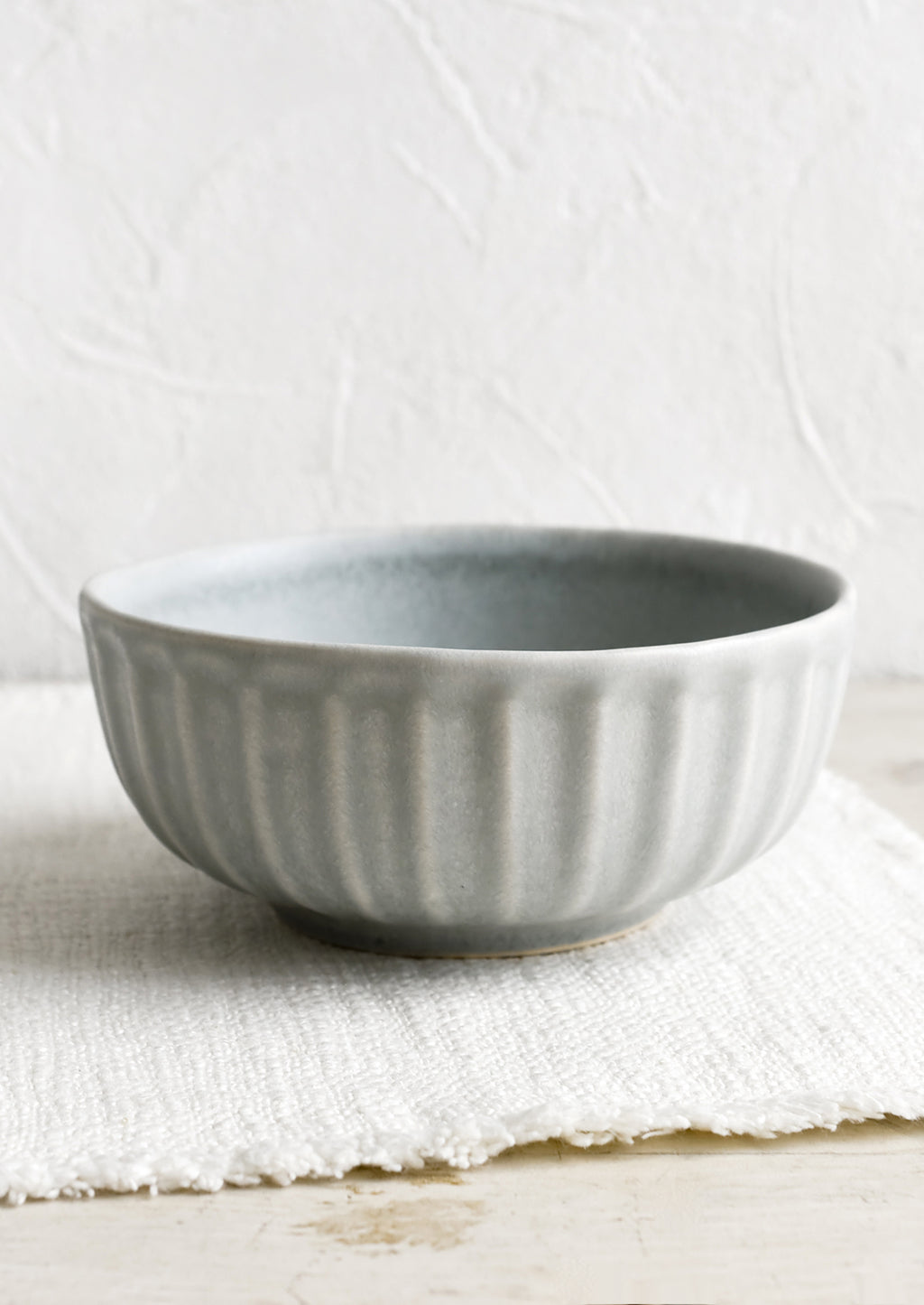 Soup Bowl: A round ceramic soup bowl with fluted texture.