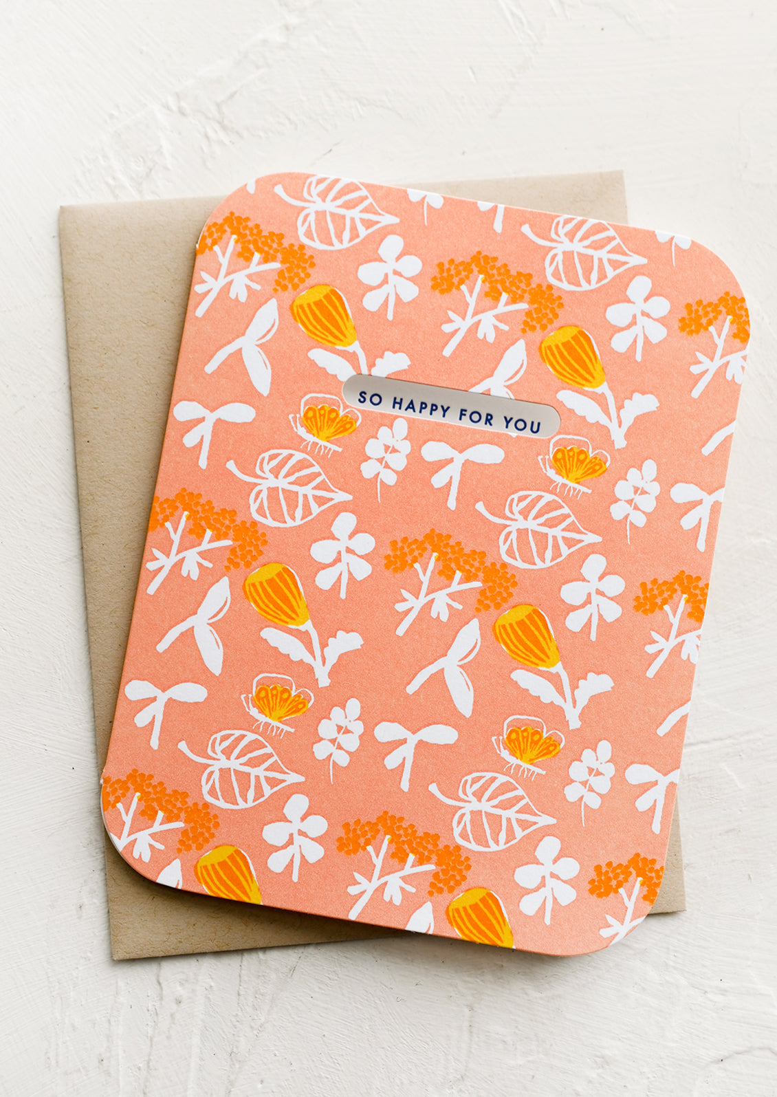 A botanical print card in peach with cutout window.