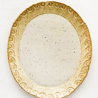 Buttermilk Speckle: An oval shaped ceramic platter in pale yellow speckle.