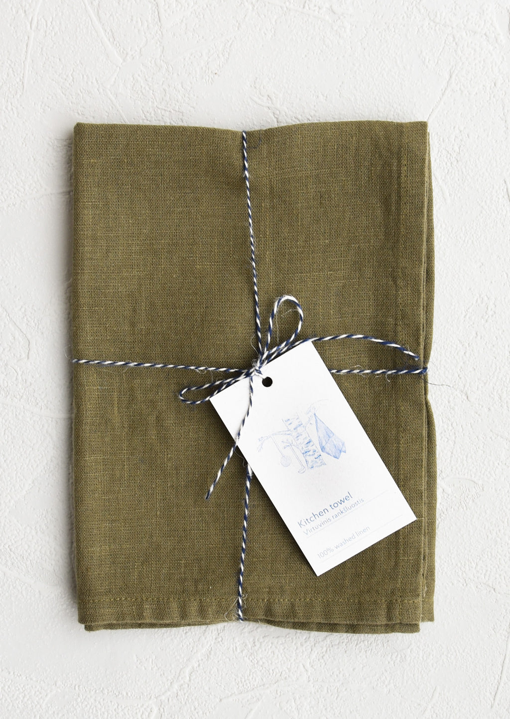Olive: A folded faded olive colored linen tea towel tied in baker's twine with a decorative hangtag