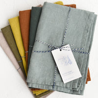 2: A stack of linen tea towels in assorted colors