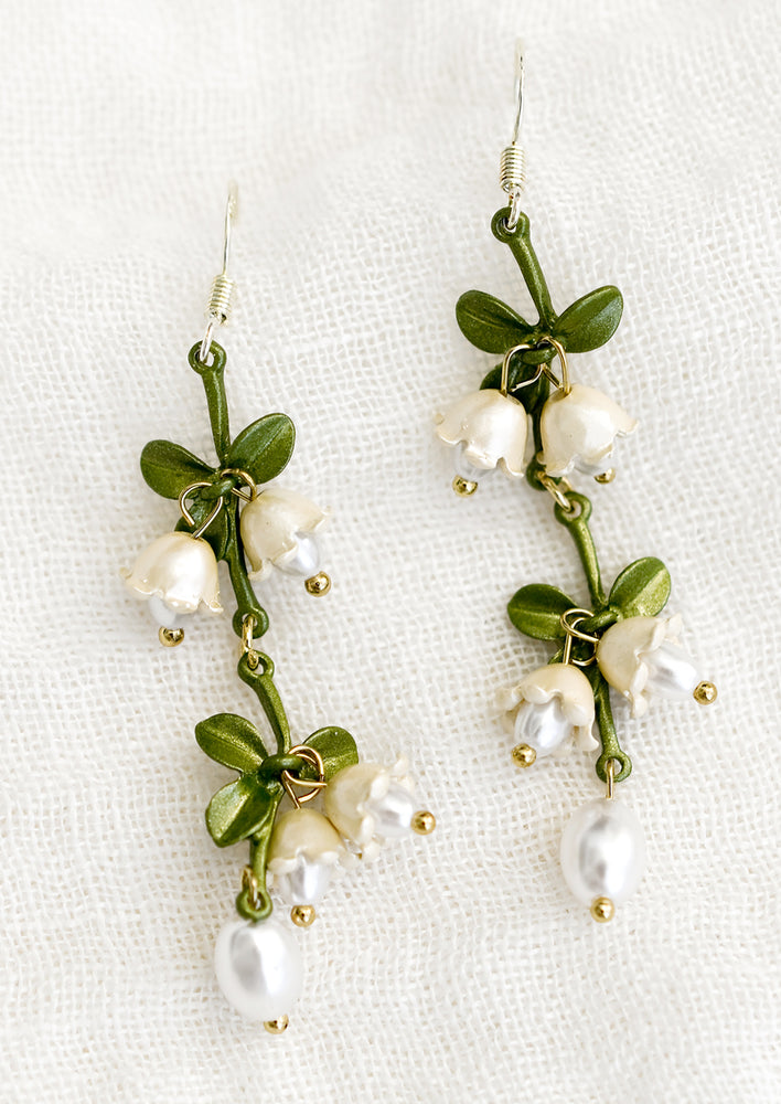 A pair of beaded drop earrings with leaf and flower beading.