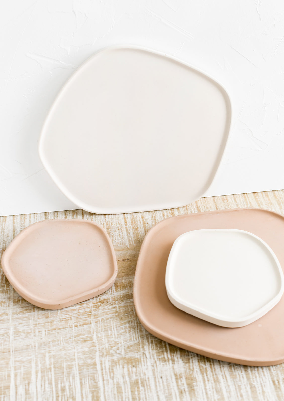 Concrete trays in asymmetrical shape in assorted sizes and colors.