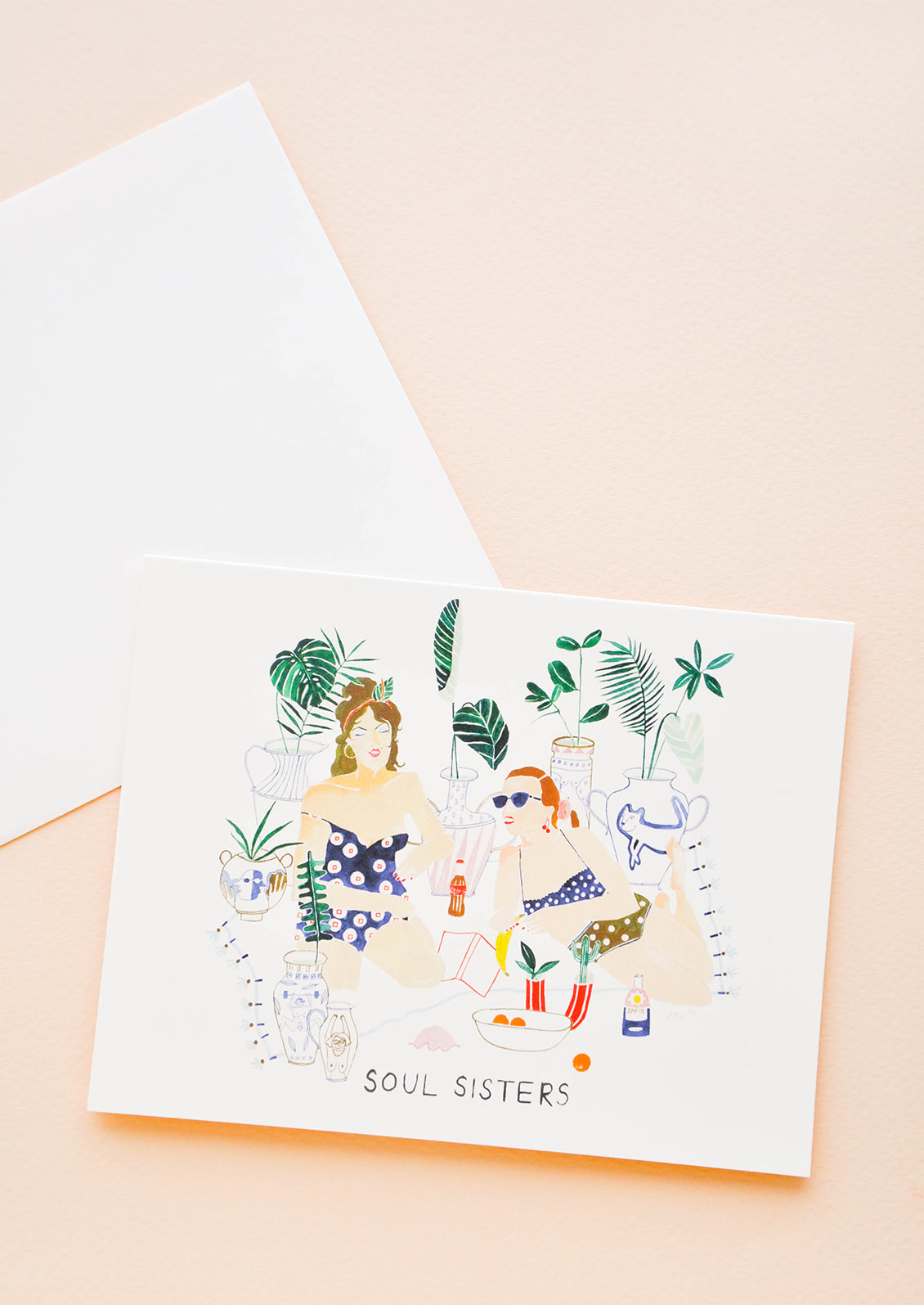 Notecard with drawing of two women on vacation and the text "Soul sisters", with white envelope.