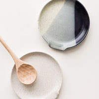 2: Circular ceramic spoon rests in varied artisan glazes, shown with wooden spoon