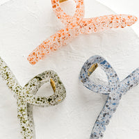 1: Three french twist style, speckled hair clips in assorted colors.