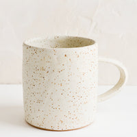 1: A speckled white coffee mug.