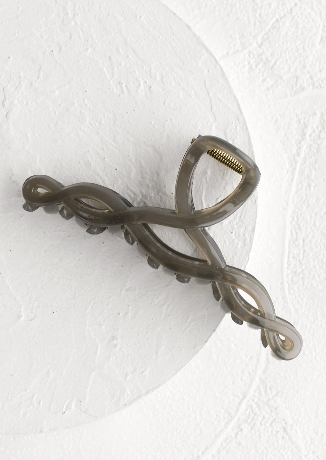 A spiral shaped hair claw in smoke grey.