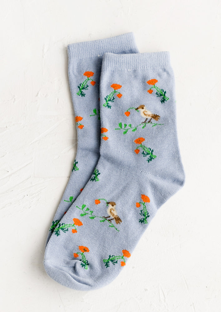 1: A pair of blue socks with floral bird print.