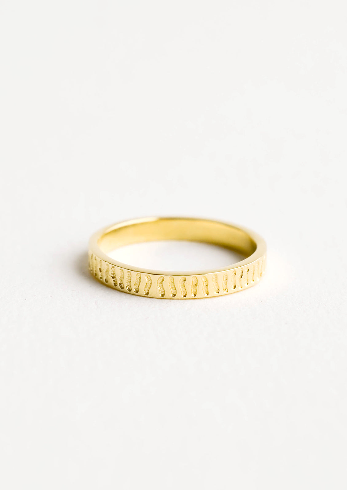 Gold band ring with squiggly lines etched all around