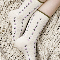 2: A pair of cream socks with purple flower vertical lines.