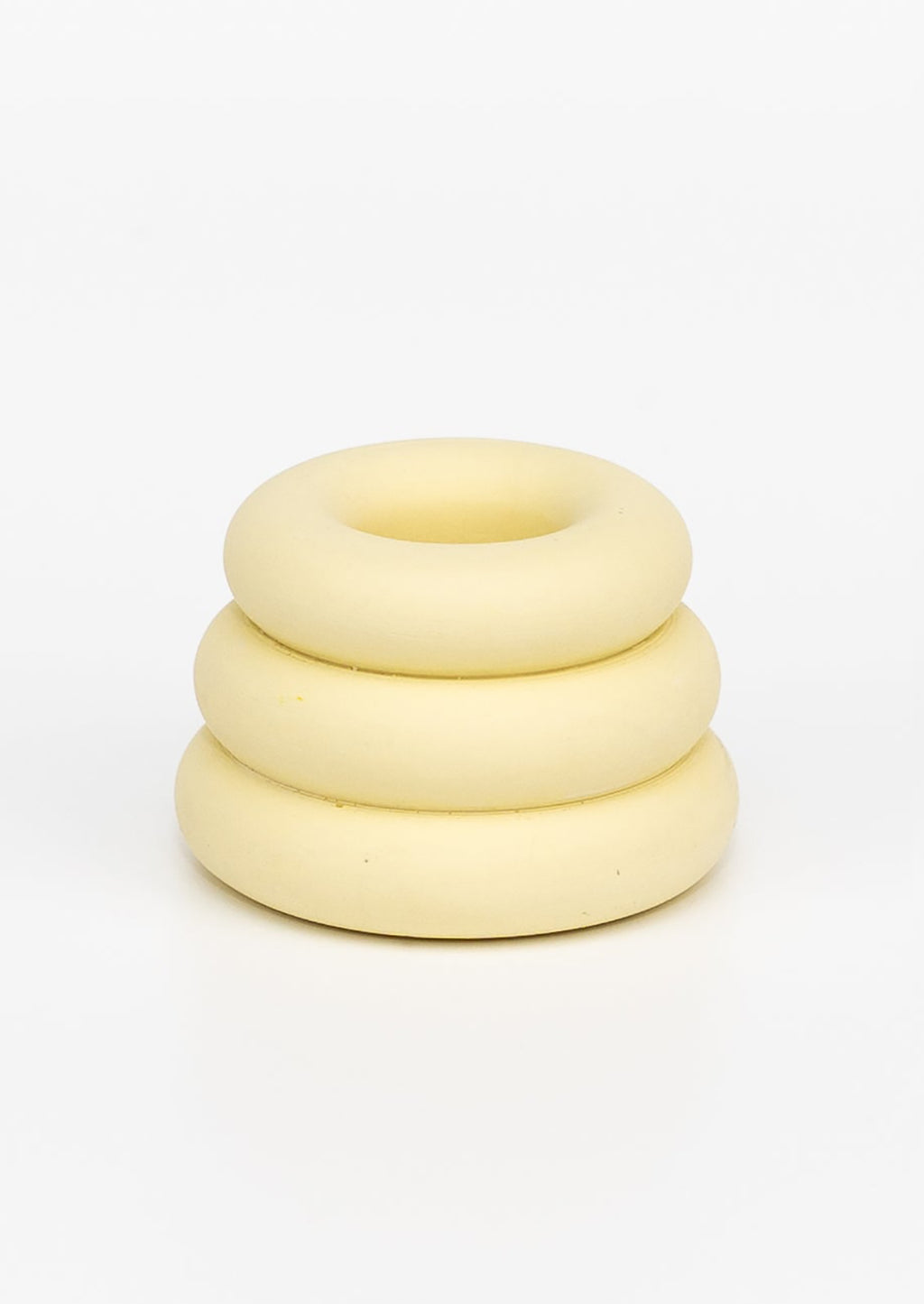 Buttercup: A taper candle holder with 3-layer stacked donut shape in pale yellow.