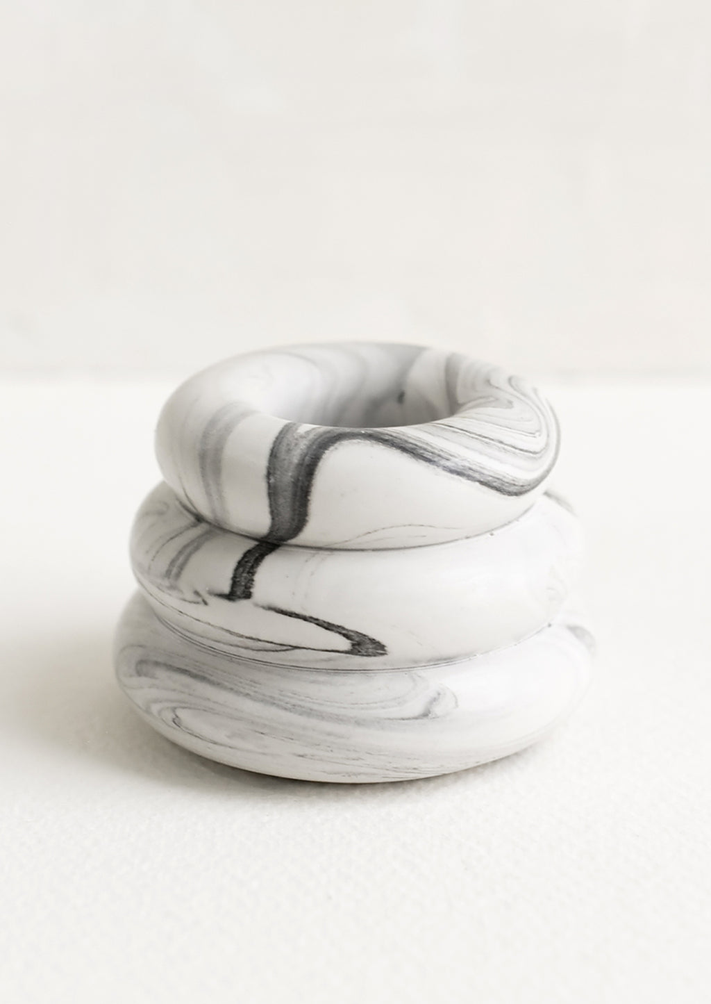 Grey Marble: A taper candle holder with 3-layer stacked donut shape in grey and white marble.