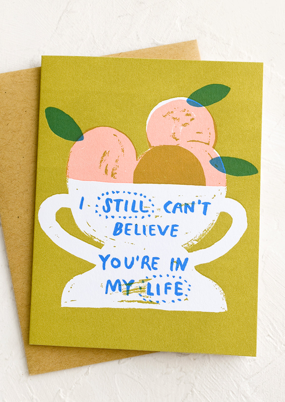 A card with still life image of fruit in a bowl, text reads "I still can't believe you're in my life".