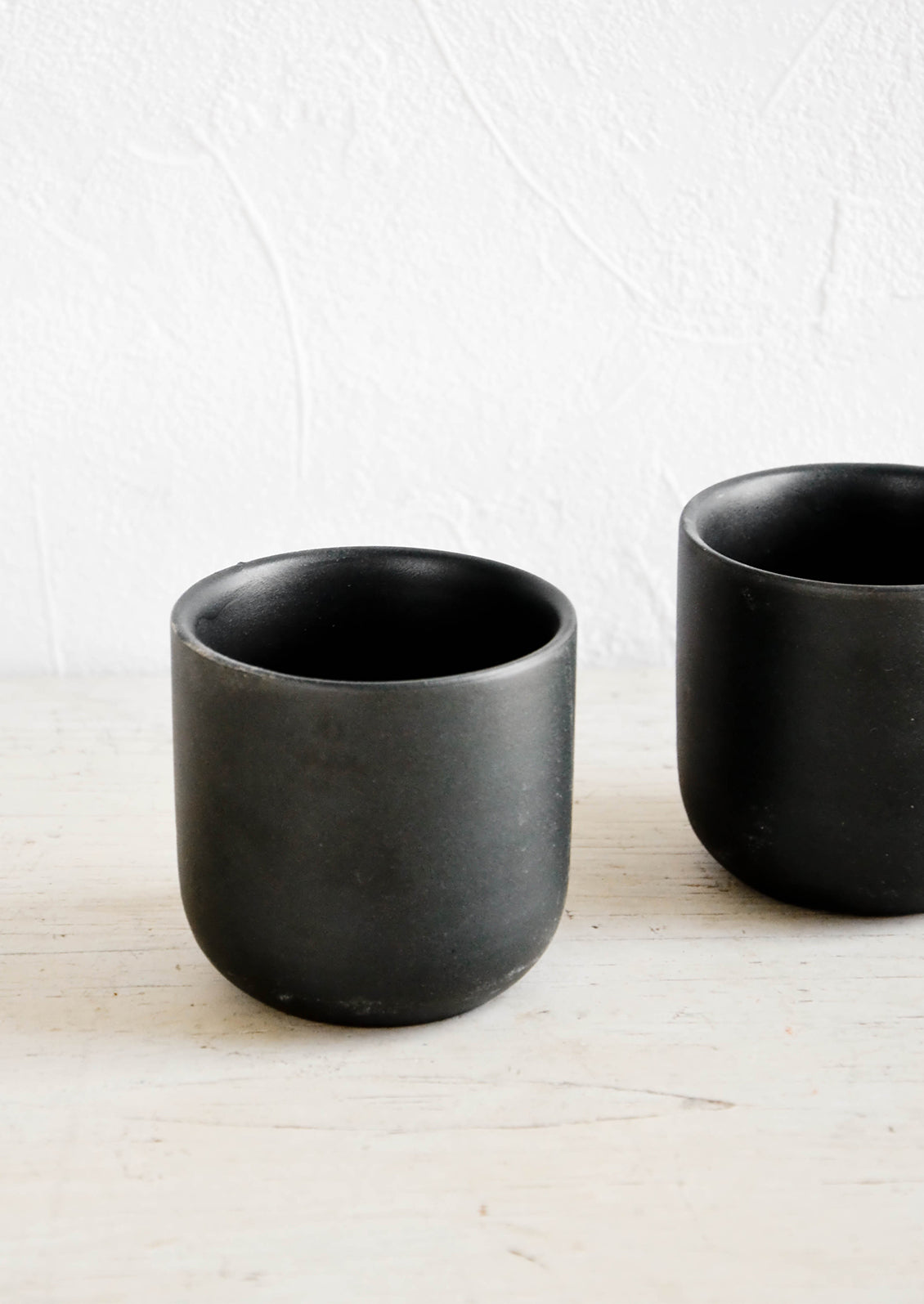 Short rounded cups in matte finished black ceramic