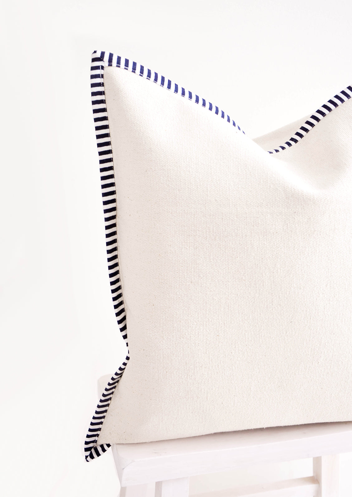 Detail of striped navy & white trim on cotton canvas throw pillow