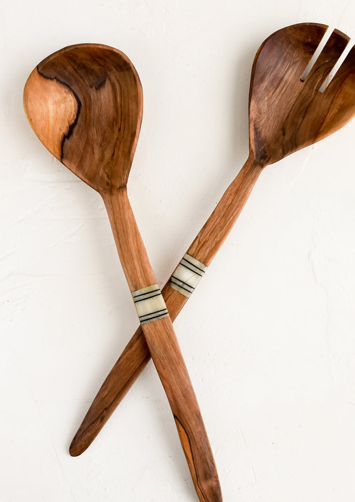 A set of olivewood serving utensils with etched bone detailing at center of handles.
