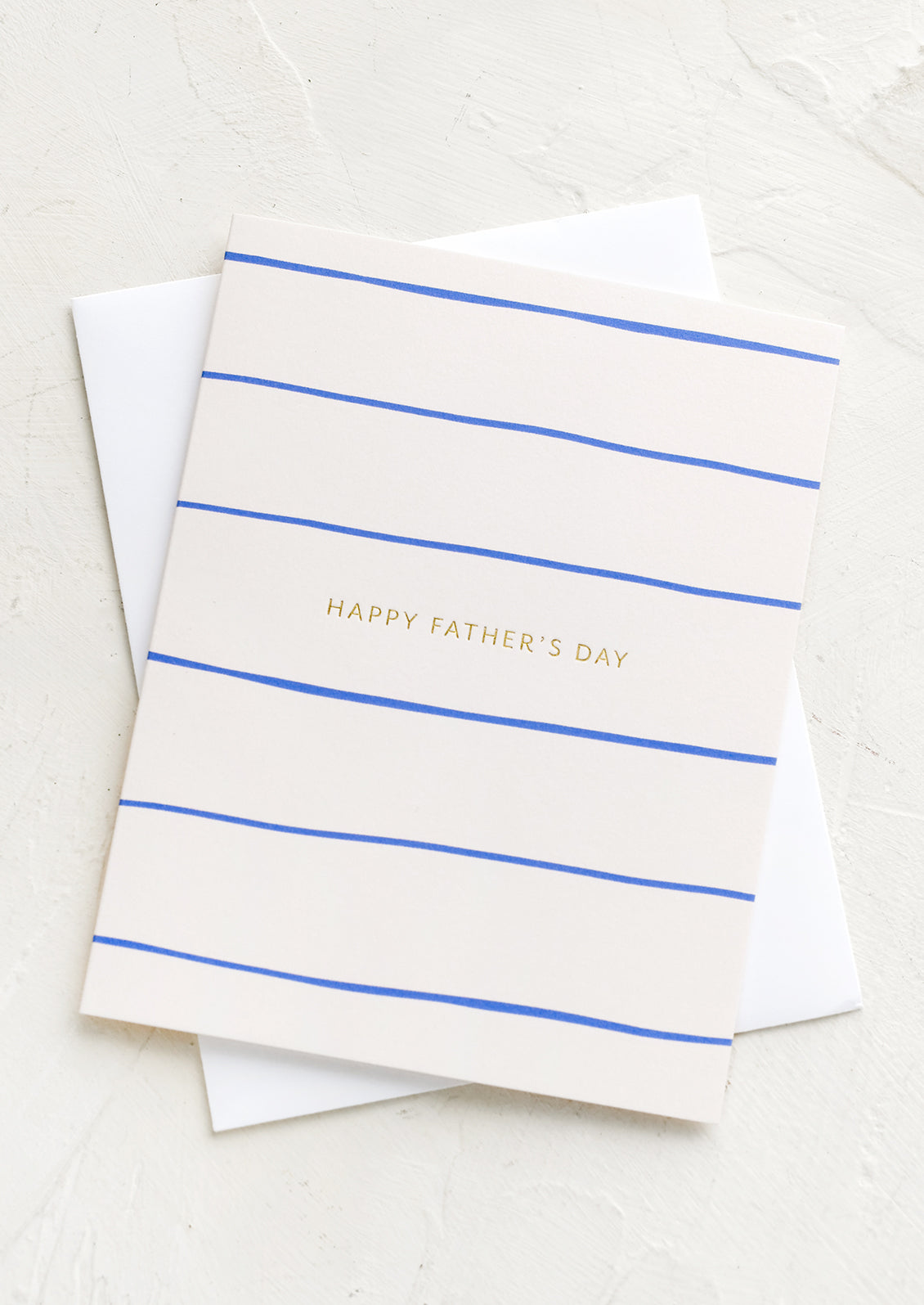 A greeting card with blue stripe pattern reading "Happy Father's Day"