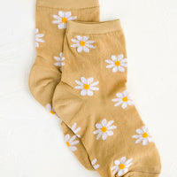 Tan: A pair of tan socks with white daisy pattern.