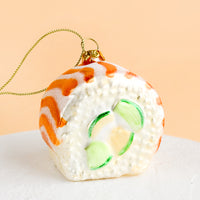 2: A decorative glass ornament in the shape of salmon avocado sushi roll.