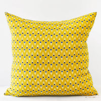 1: A block printed pillow with a yellow, blue, and white floral design.