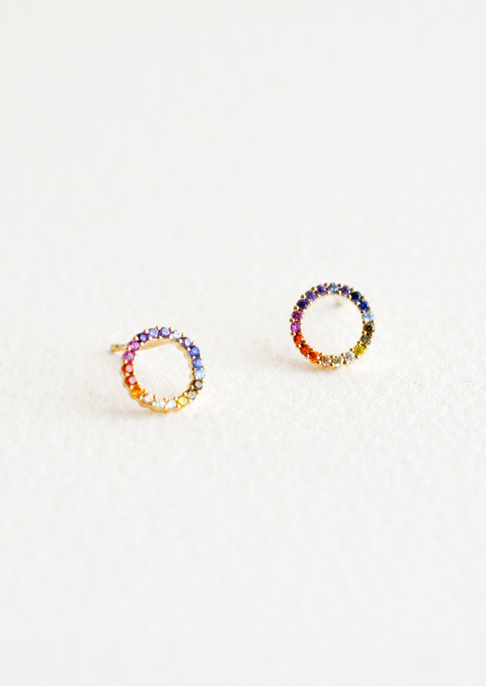 Stud earrings in open circle shape with colored rainbow crystals around.