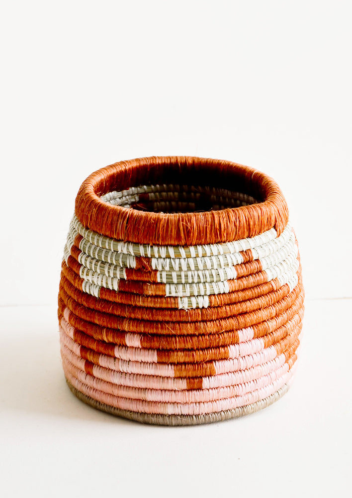 Woven sweetgrass basket with open top, in chevron pattern in pink and terracotta