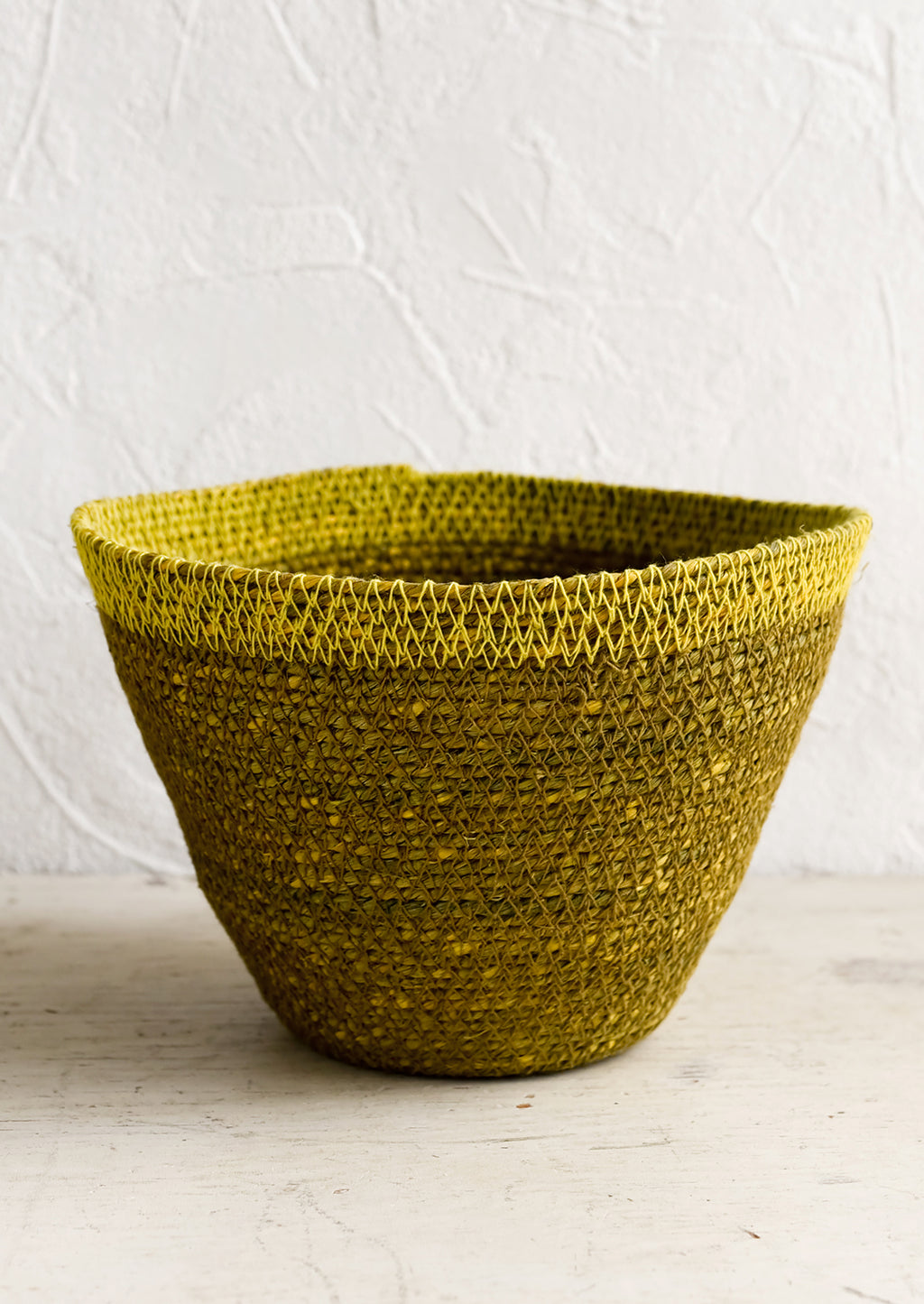 Ochre / Yellow: A tapered seagrass storage basket in ochre with yellow rim.