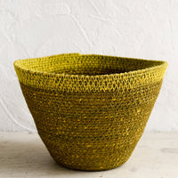 Ochre / Yellow: A tapered seagrass storage basket in ochre with yellow rim.
