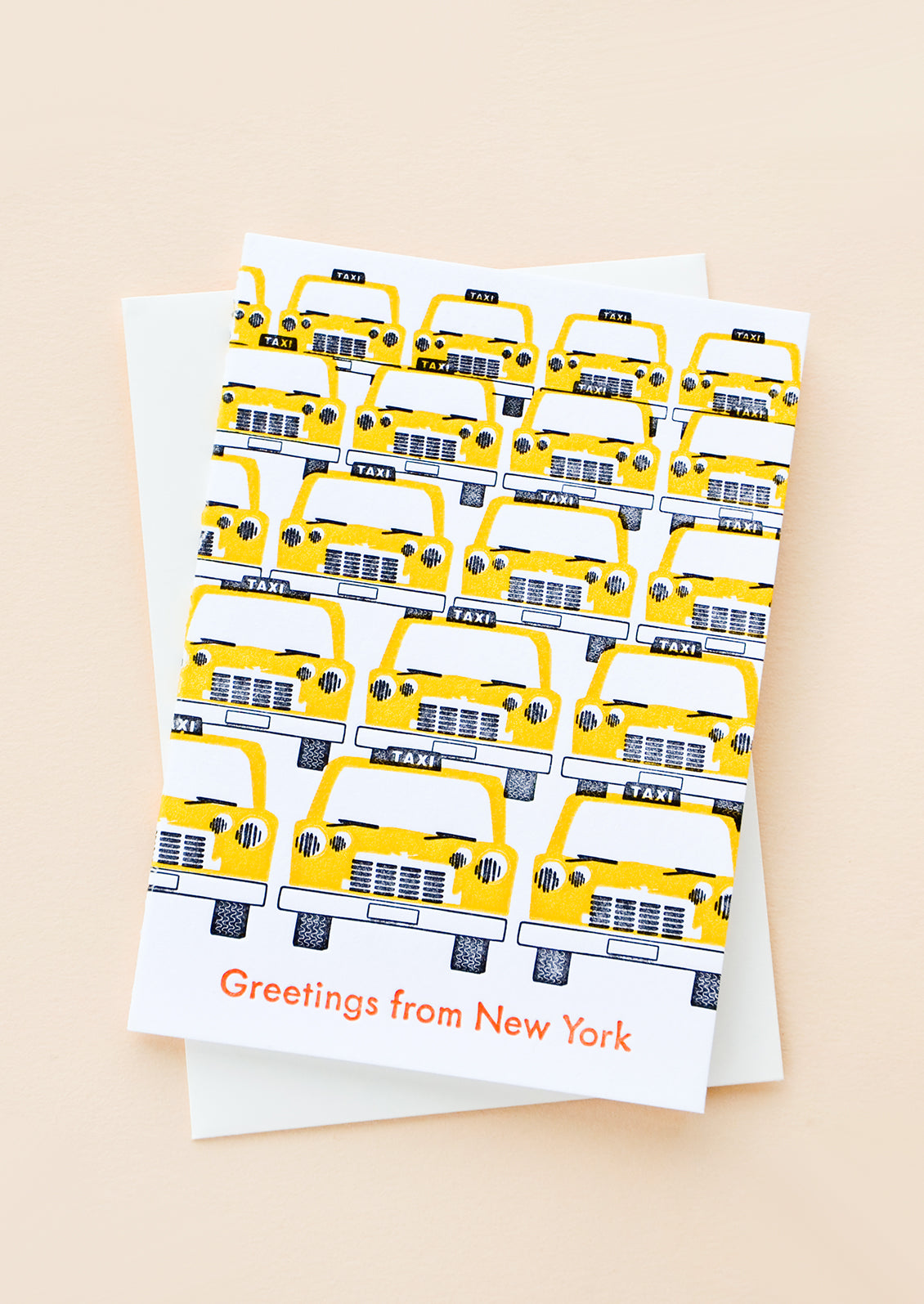 Greeting card with rows of yellow taxis and red text at bottom reading "Greetings from New York"
